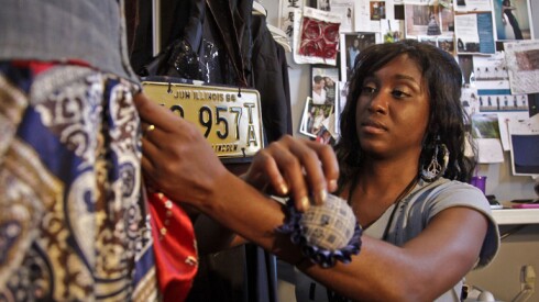 A fashion designer and entrepreneur works in her home studio.