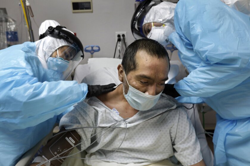 doctors treat a COVID patient in the hospital.