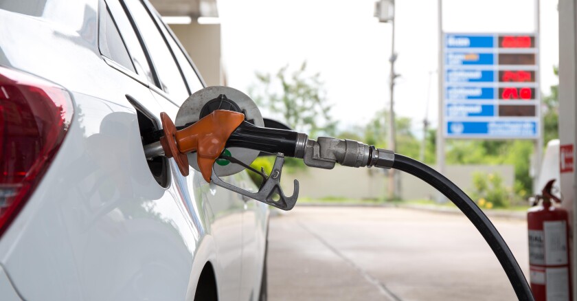 A car being filled with fuel at a gas station.