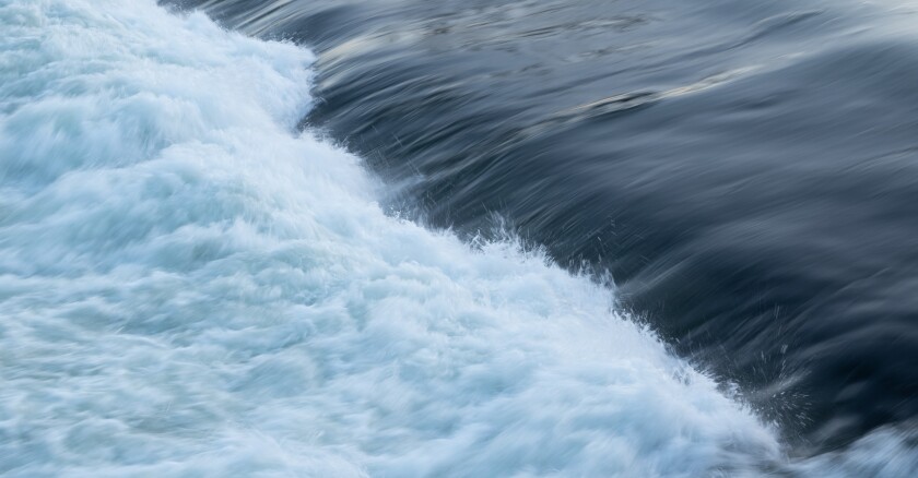 water flowing over a dam
