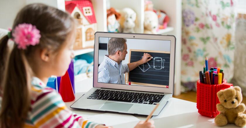 Middle-aged distance teacher having video conference call with pupil using webcam. Online education and e-learning concept. Home quarantine distance learning and working from home.