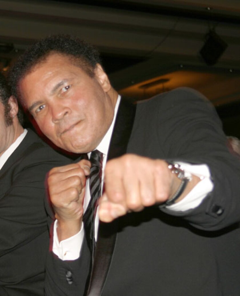 An aging Ali boxes the camera.jpg