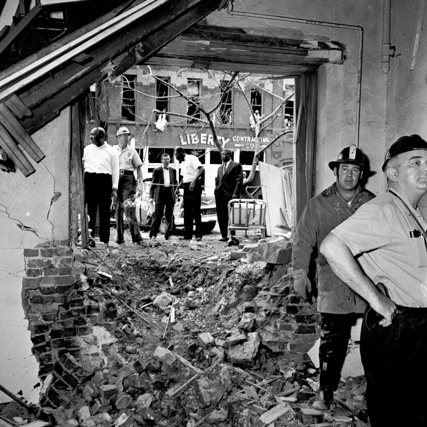 Rescue workers surveying the remains of the church’s basement lounge.