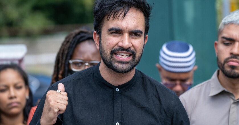 Zohran Mamdani gesturing with one hand while speaking.