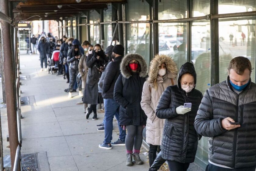Chicago voters wait in line on the last day of early voting in November 2020. A regression analysis of turnout in the presidential election found that strong voter preferences, not voting procedures, drove the outcome.
