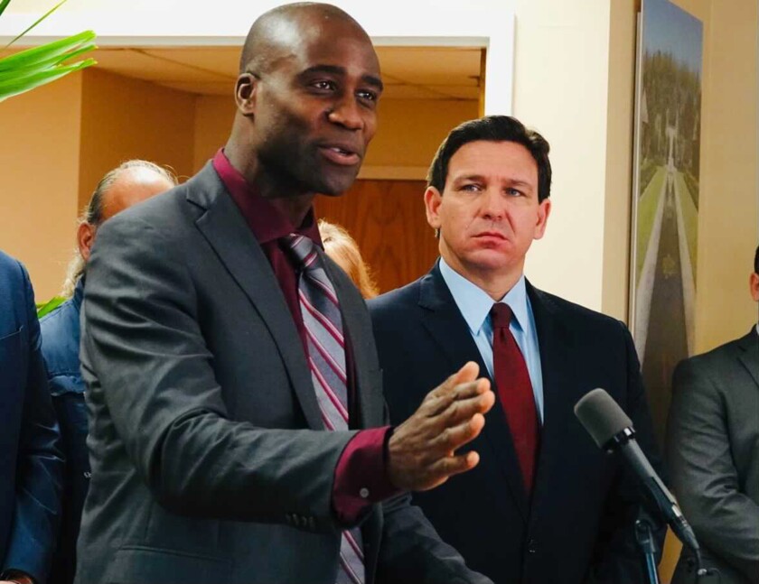 Florida Surgeon General Joseph Ladapo and Gov. Ron DeSantis at a news conference