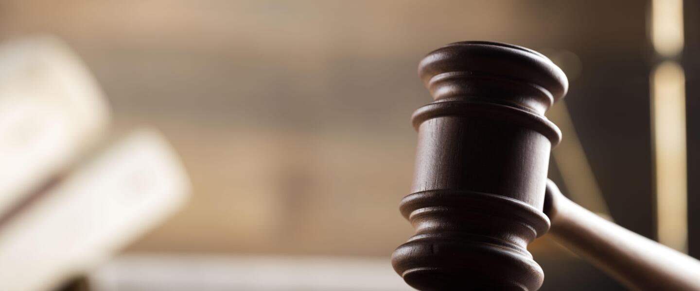 law theme, mallet of the judge, wooden desk, scales of justice, books, statue of justice and hourglass