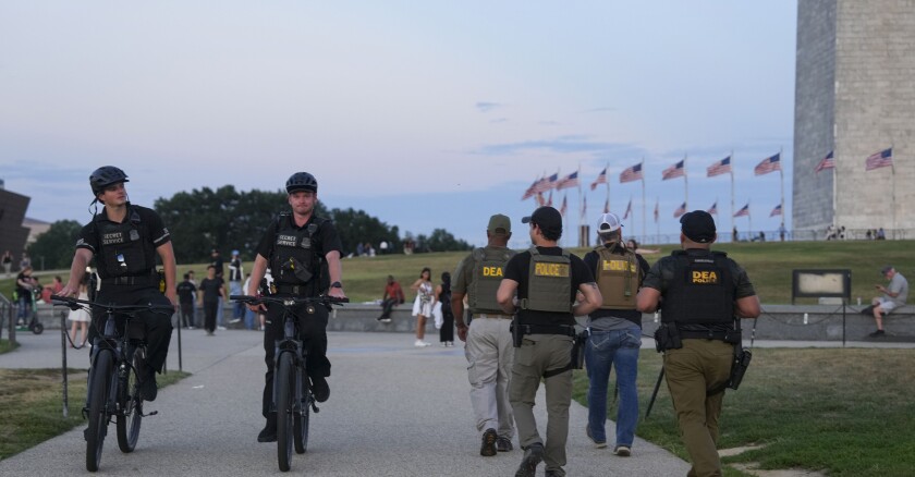 Park Police pass by Drug Enforcement Administration personnel along the National Mall on Aug. 12, 2025, in Washington, D.C.