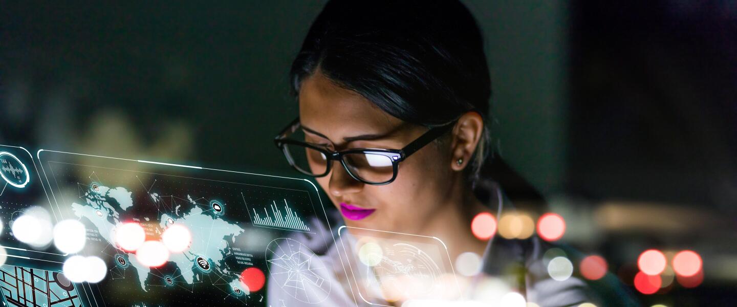 businesswoman looking at futuristic interface screen.