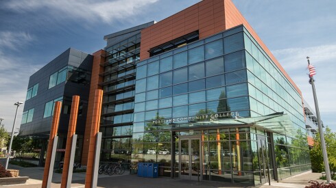 The exterior of the Portland Community College Willow Creek Center, which is largely glass from this angle, on a sunny day.