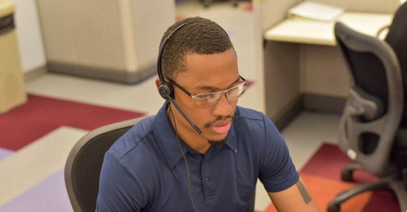 NYC311 representative Donovan Nesbeth-Lauderdale taking a call.