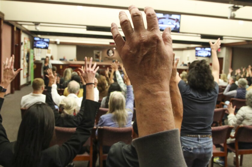 Audience members wave their hands in support