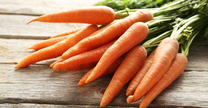 Fresh,And,Sweet,Carrot,On,A,Grey,Wooden,Table