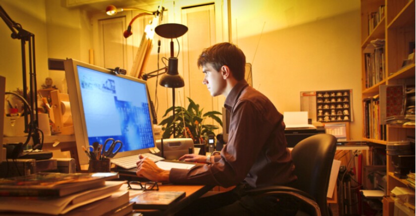 A person working on a computer in their home.