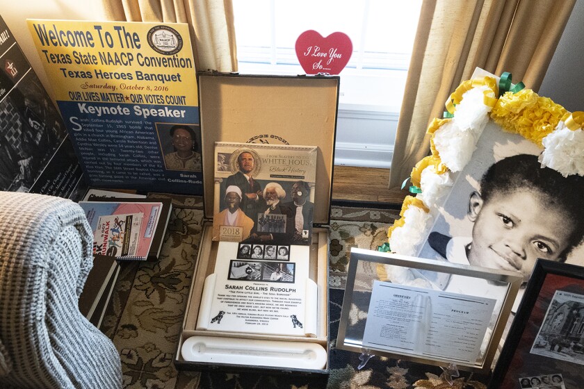 Framed photographs, newspaper clippings and other mementos in Sarah Collins Rudolph’s living room.