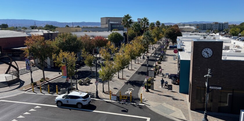 Aerial view of a street converted to a pedestrian area with trees and bike lanes in Lancaster, Calif.