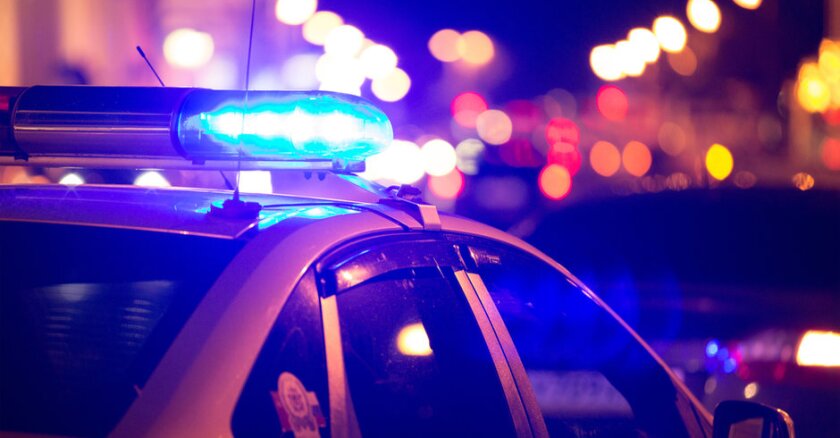 A police vehicle at night with its light bar illuminated.