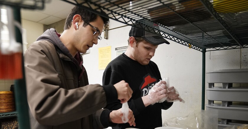 two men working in a storage room
